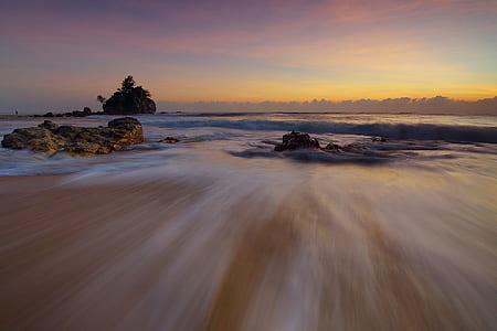 timelapse photograph of low tide sea during golden hour thumbnail
