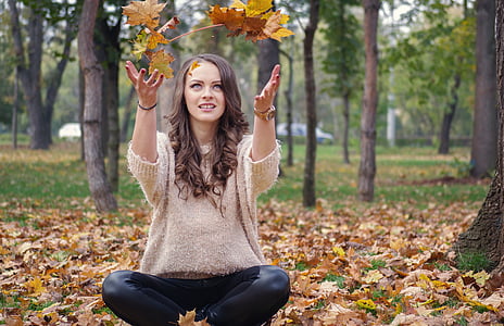 woman sitting on ground under trees thumbnail