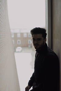 man leaning on brown wall thumbnail