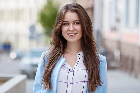 woman wearing white and black shirt with blue blazer thumbnail
