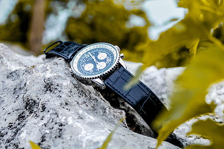 Selective Focus Photography of Chronograph Watch on Rock thumbnail