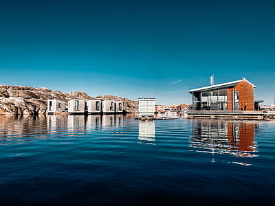 house surrounded by body of water during daytime thumbnail