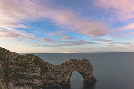 landscape photo of cliff surrounded by body of water thumbnail