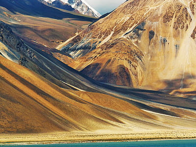 mountain range near body of water thumbnail