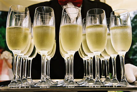 filled clear glass champagne flutes thumbnail