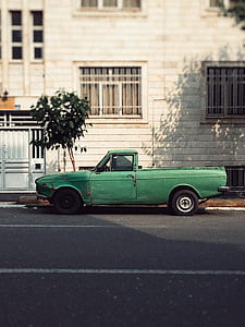 green single cab pickup truck parked on road thumbnail