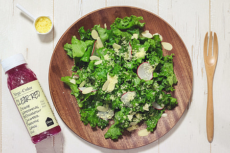 green leafy vegetable salad on round brown plate thumbnail