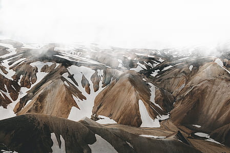 aerial photography of foggy snow-covered brown mountains thumbnail