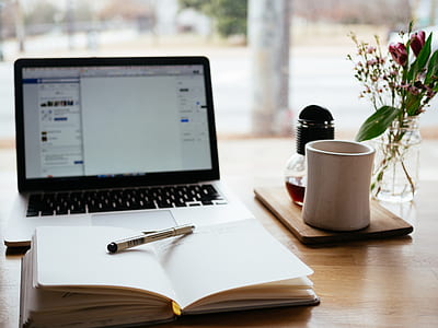 white pen on open book beside white ceramic mug thumbnail