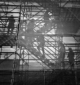 grayscale photography of people on scaffolding thumbnail