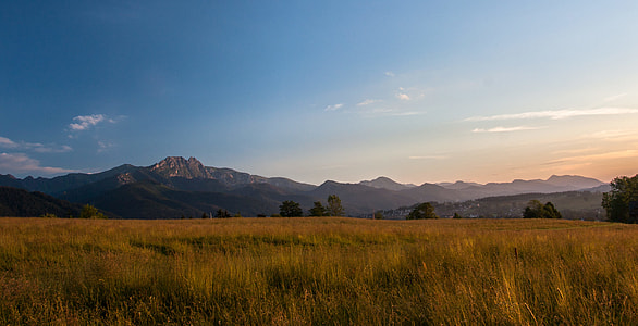 landscape photography of mountains and grass field thumbnail
