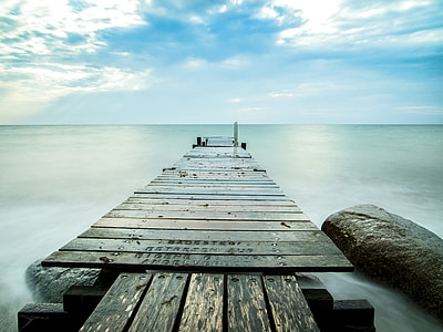 brown wooden dock under white clouds during daytime thumbnail