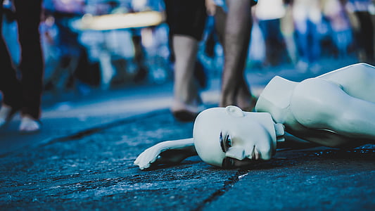 white mannequin on black concrete pavement thumbnail