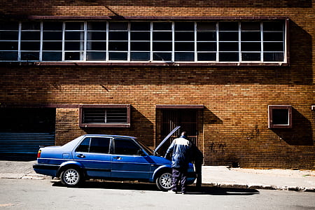 two person at the park blue sedan thumbnail
