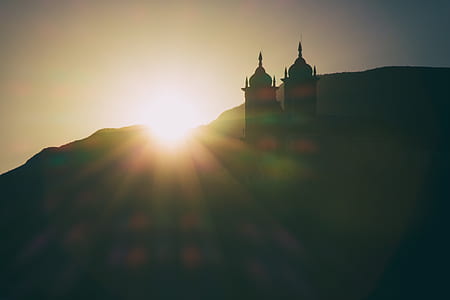 silhouette photo of two castles on hills thumbnail