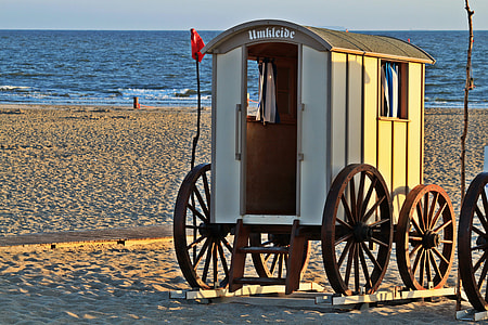 white carousel on sand near body of water thumbnail