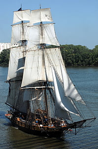 white sailing ship surrounded with green trees thumbnail