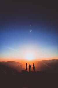 silhouette of three people on top of mountain thumbnail