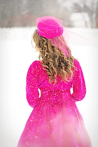 person wearing fuchsia long dress and headdress thumbnail