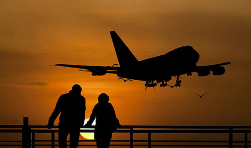 Photo illustration of people at a railing against a sunset with jumbo jet flying over. thumbnail