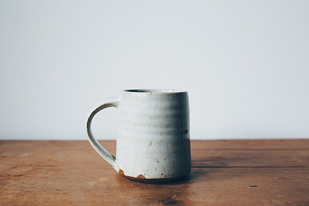 white ceramic mug on brown wooden surface thumbnail