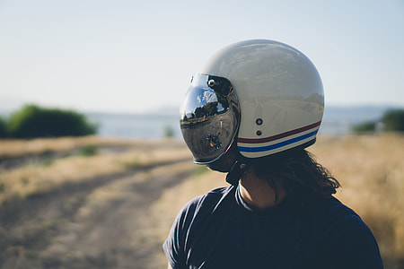 person wearing white, red, and blues tripe half-face helmet during daytime thumbnail