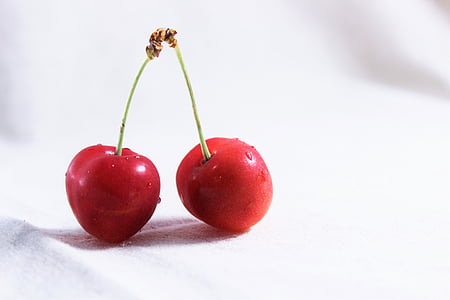 two red cherries on white surface thumbnail