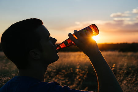 person drinking brown translucent glass bottle thumbnail
