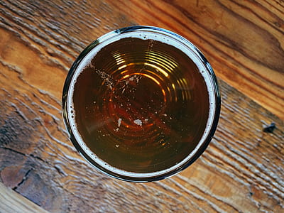 round amber glass cup on brown surface thumbnail
