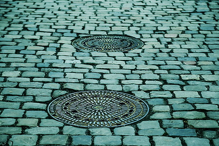two gray steel manhole cover thumbnail