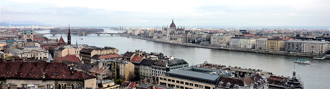 group of buildings near body of water during daytime thumbnail