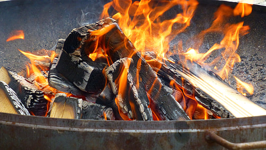 black fire pit with burning firewood thumbnail