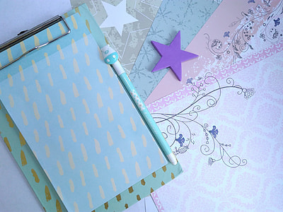 white and teal clipboard near teal pen thumbnail