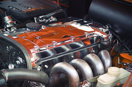 close up photography of orange and gray vehicle engine thumbnail