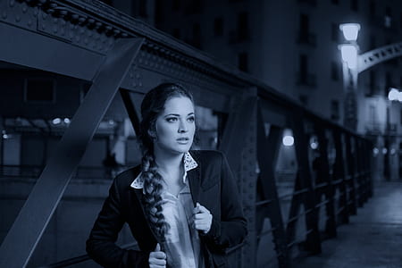 grayscale tilt-shift lens photo of a woman near metal handrail thumbnail