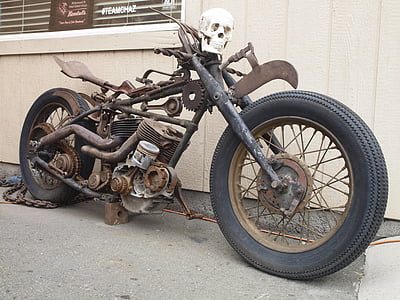 gray and brown steampunk-themed motorcycle parked beside building at daytime thumbnail