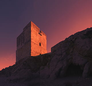 concrete building on hilltop during sunset thumbnail