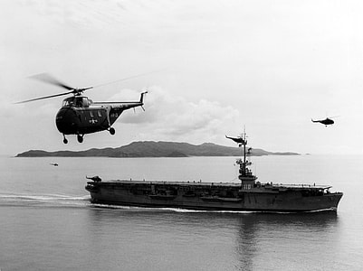 US Navy Sikorsky HO4S flying near USS Sicily during Korean War thumbnail