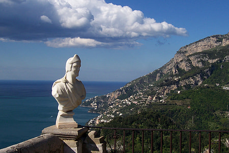 statue of male near railings under blue sky thumbnail
