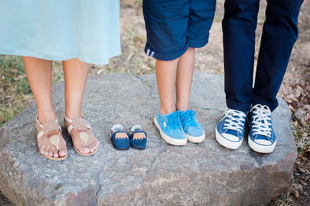 three people standing on brown rock thumbnail