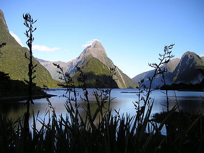 low angle photo of mountains near sea at daytime thumbnail