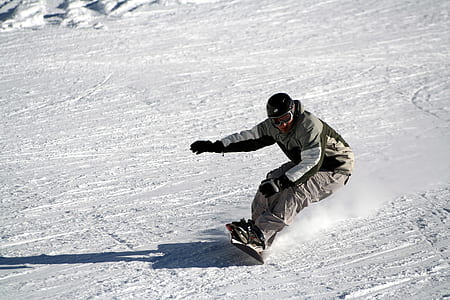man snowboard on snow covered ground during daytime thumbnail