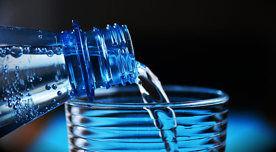 Close-up of Bottle Pouring Water on Glass thumbnail