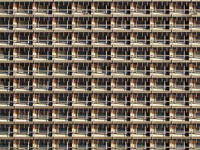fill the frame photography of brown building thumbnail