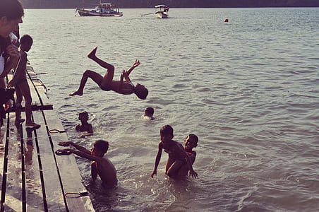 children swimming on body of water thumbnail