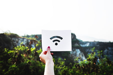 person holding wifi logo printed paper thumbnail