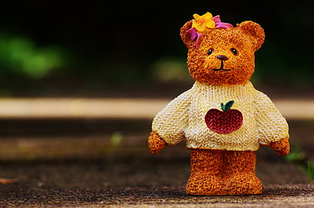 brown bear ceramic figurine on flooring outdoors thumbnail