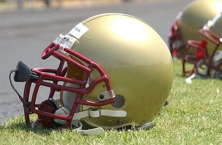 green and red football helmet on green grass thumbnail