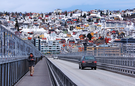 man in black coat walking beside the road thumbnail