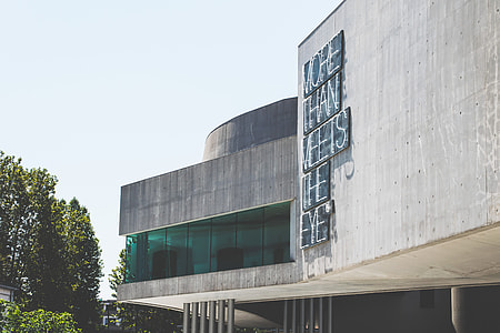 gray concrete building near trees thumbnail